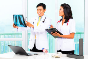 nurse and doctor reviewing medical records